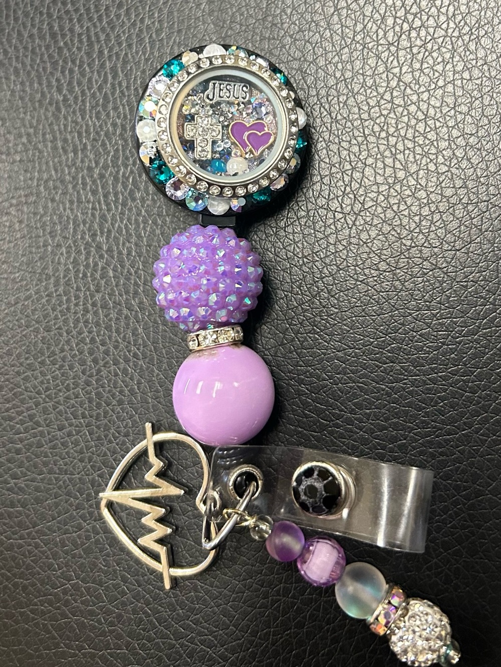 Rhinestone 'Jesus' Badge Reel with Purple Beads